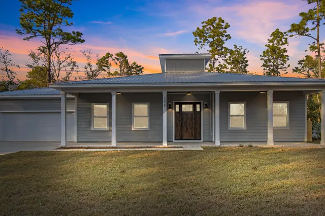 an aerial view of a house with a yard basket ball court and outdoor seating