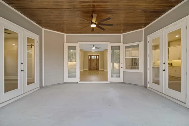 an empty room with windows and pillars in it