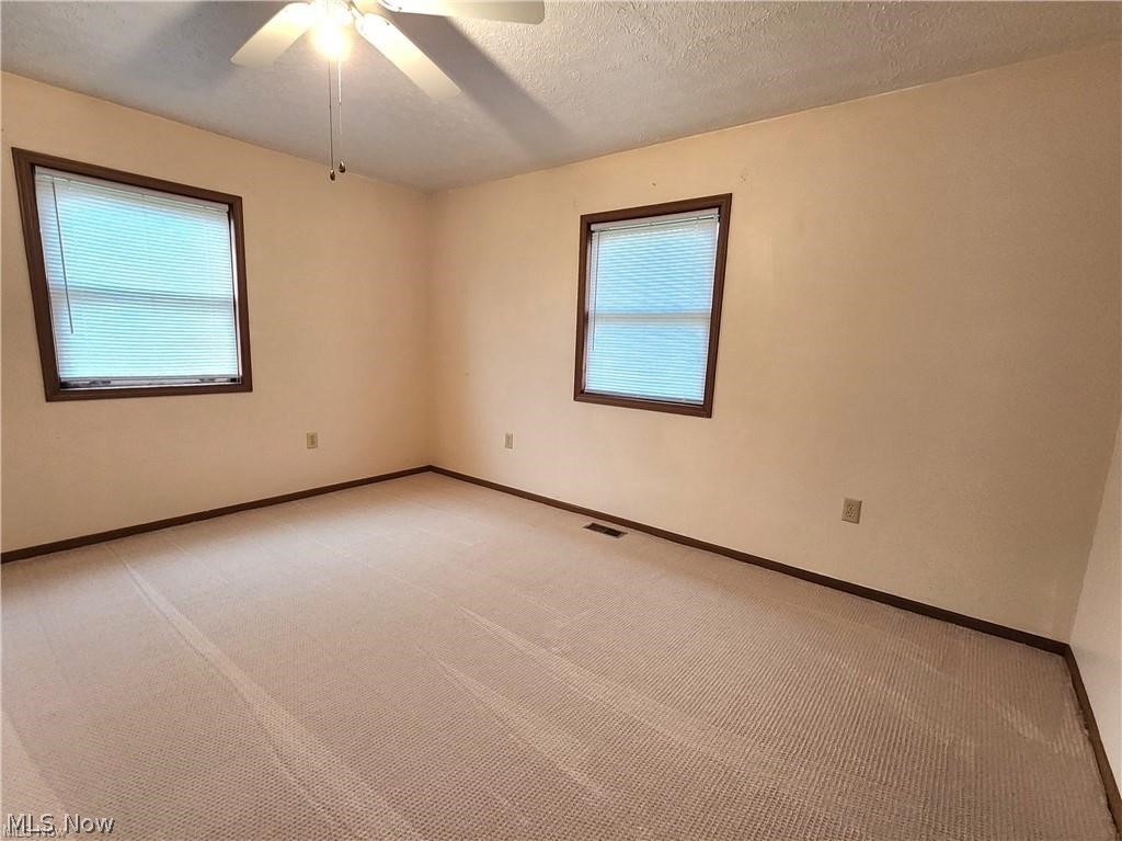 10345 Marne Road Frazeysburg, OH 43822 - Photo 29 of 50 Carpeted empty room with ceiling fan and a textured ceiling