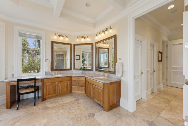 1714 Ridge Point Drive Bountiful, UT 84010 - Photo 69 of 132 Corner vanity with light wood cabinetry, multiple mirrors, and dual sinks