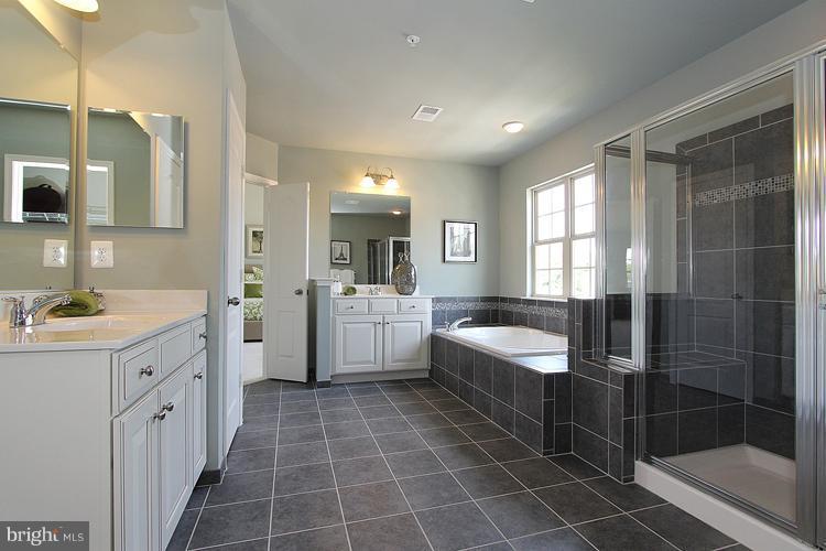 3041 Bel Pre Road Silver Spring, MD 20906 - Photo 21 of 28 a bathroom with a double vanity sink mirror and bathtub