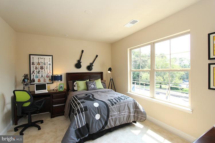 3041 Bel Pre Road Silver Spring, MD 20906 - Photo 24 of 28 a bedroom with a bed and a table in it