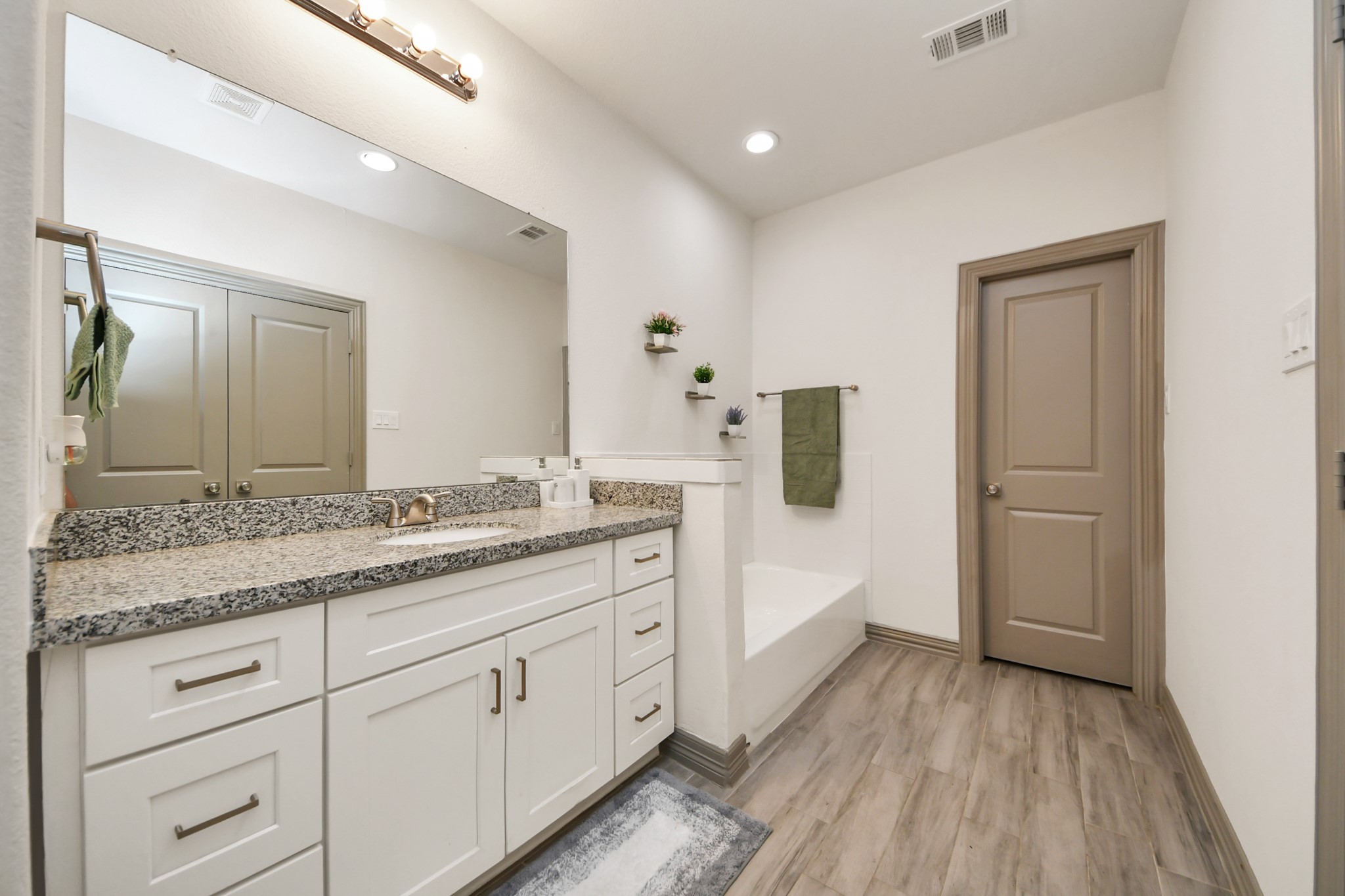 5334 Pershing Street Houston, TX 77033 - Photo 8 of 43 a spacious bathroom with a granite countertop sink and a mirror
