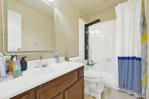 a bathroom with a sink a toilet and a large mirror