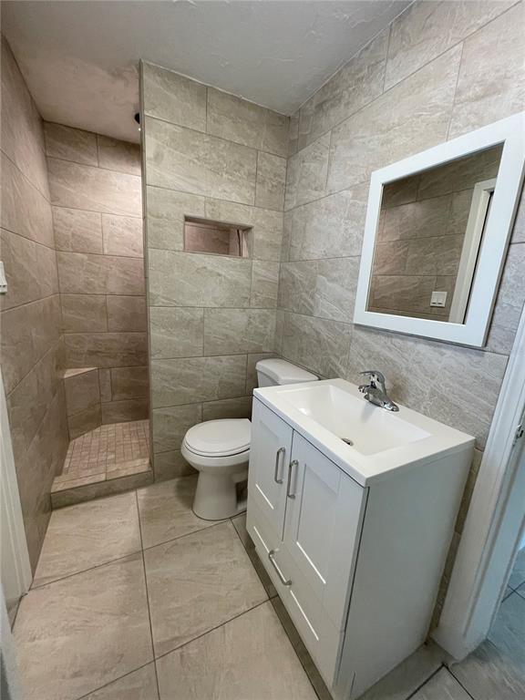 828 South Tuttle Avenue, Unit B Sarasota, FL 34237 - Photo 11 of 63 a bathroom with a sink a toilet and shower