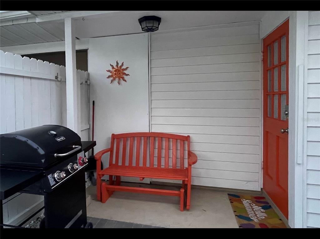 828 South Tuttle Avenue, Unit B Sarasota, FL 34237 - Photo 18 of 63 a blue bench sitting in front of a door