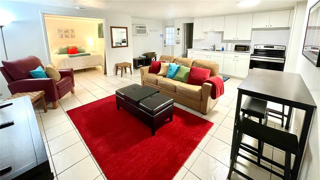 828 South Tuttle Avenue, Unit B Sarasota, FL 34237 - Photo 2 of 63 a living room with furniture kitchen view and a wooden floor
