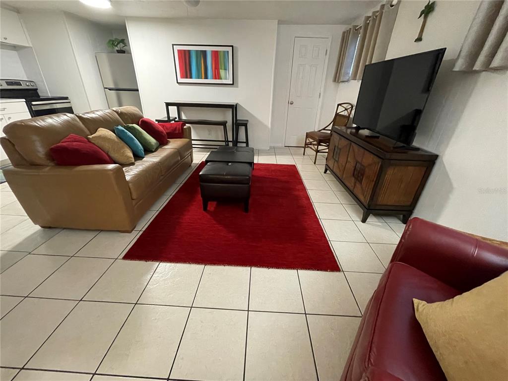 828 South Tuttle Avenue, Unit B Sarasota, FL 34237 - Photo 5 of 63 a living room with furniture and a flat screen tv