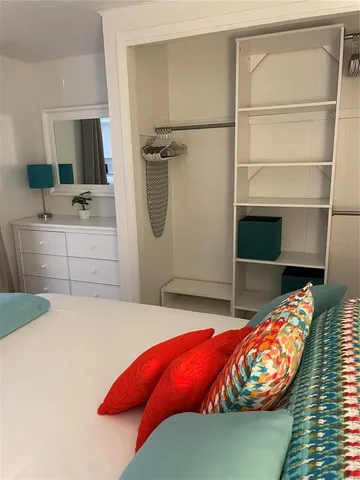 a bedroom with a bed and a dresser