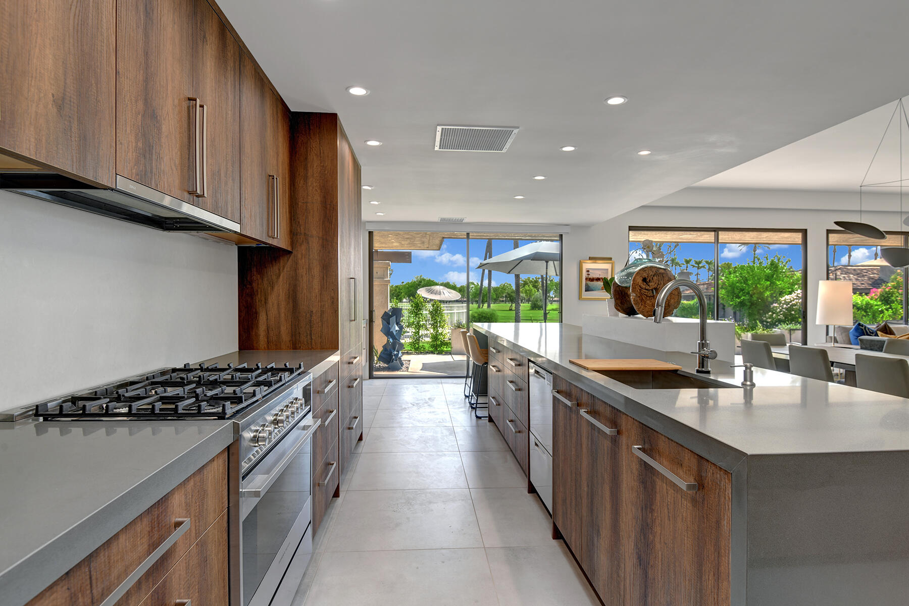 73 Princeton Drive Rancho Mirage, CA 92270 - Photo 11 of 44 a kitchen with stainless steel appliances kitchen island granite countertop a sink and cabinets