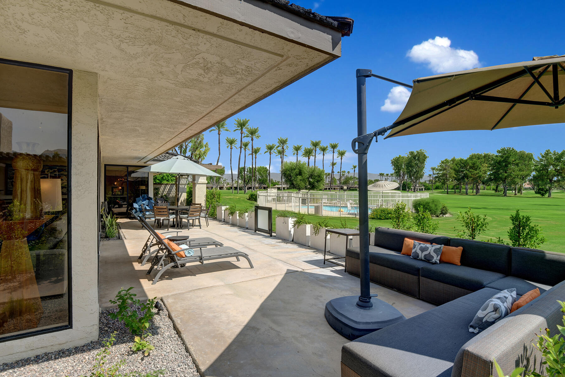 73 Princeton Drive Rancho Mirage, CA 92270 - Photo 40 of 44 a view of a patio with swimming pool table and chairs