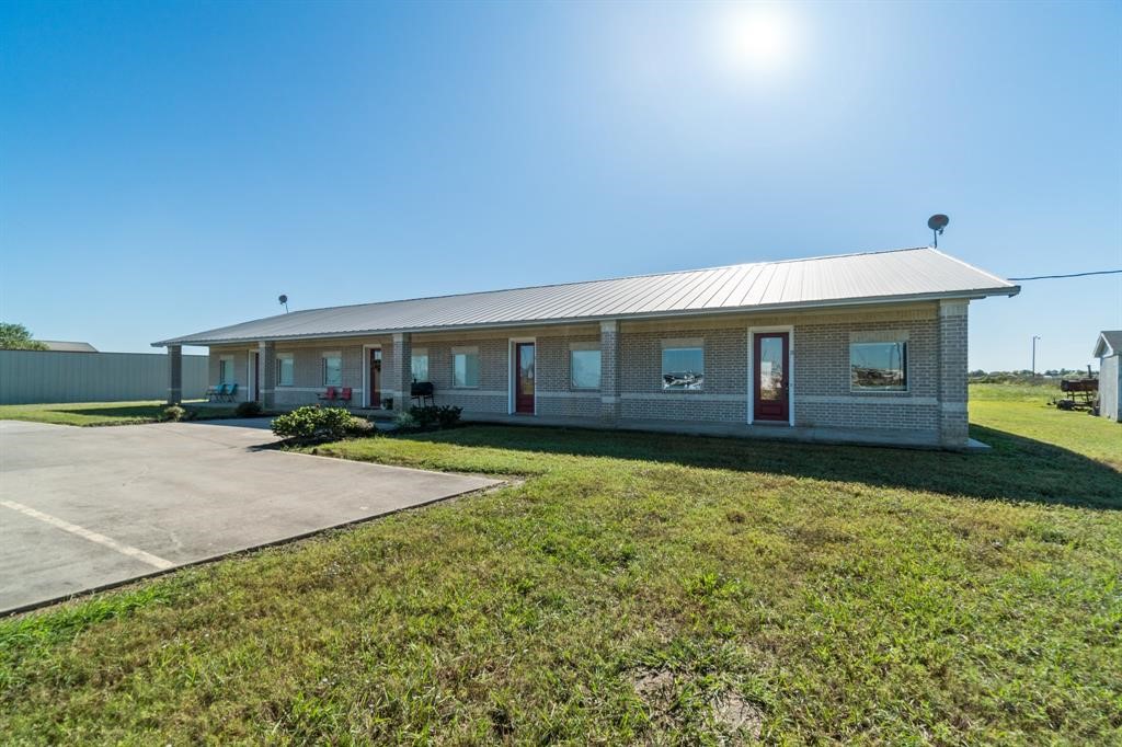 6500 South Fm 565 Rd Cove Cove, TX 77523 - Photo 1 of 8 a view of a house with backyard and porch
