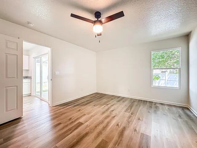 wooden floor in an empty room with a window