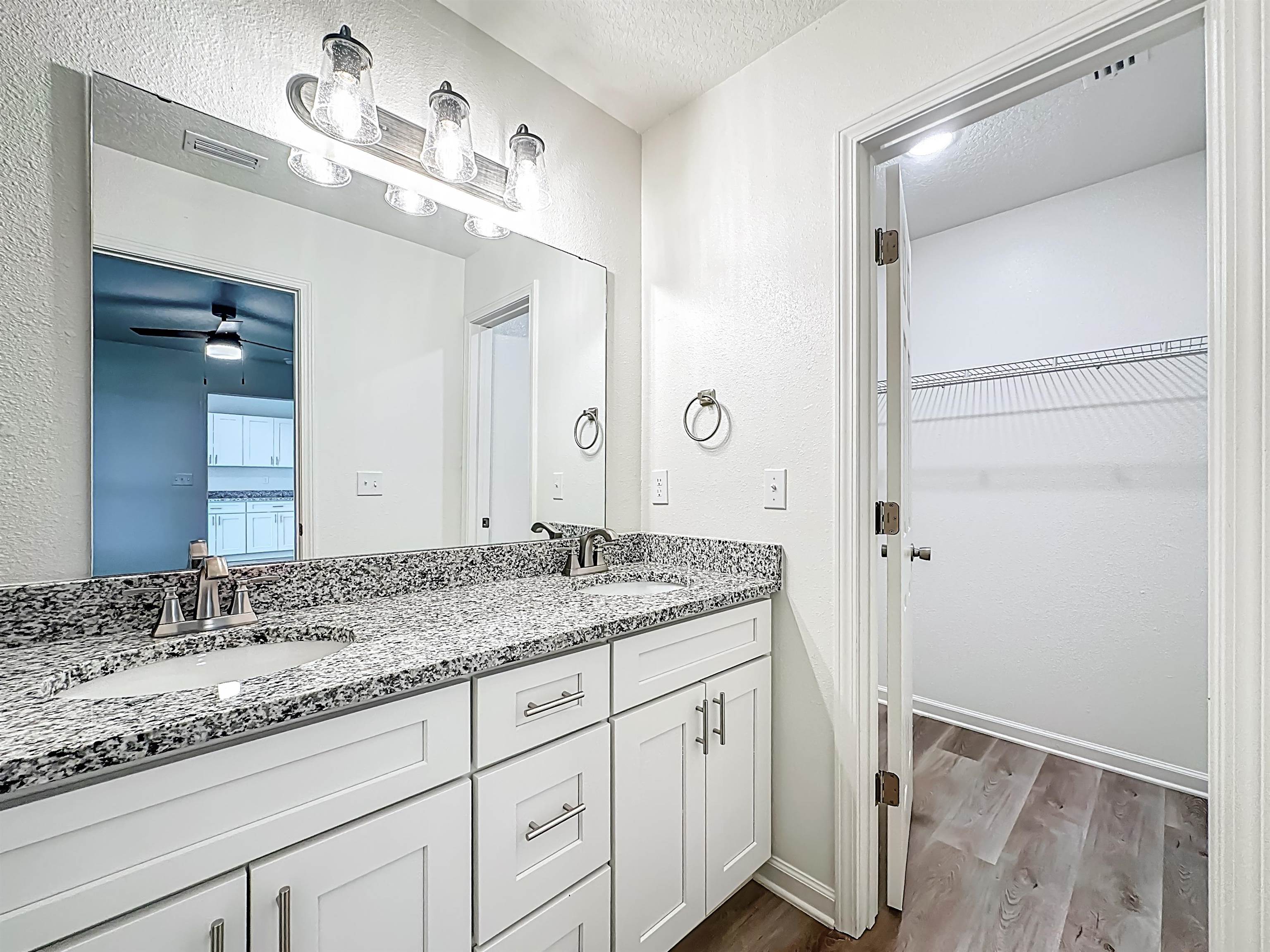 780 West 5th Street St. Augustine, FL 32084 - Photo 14 of 30 a bathroom with a granite countertop sink and a mirror