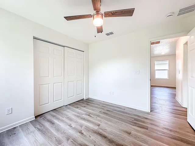 wooden floor in an empty room with a window