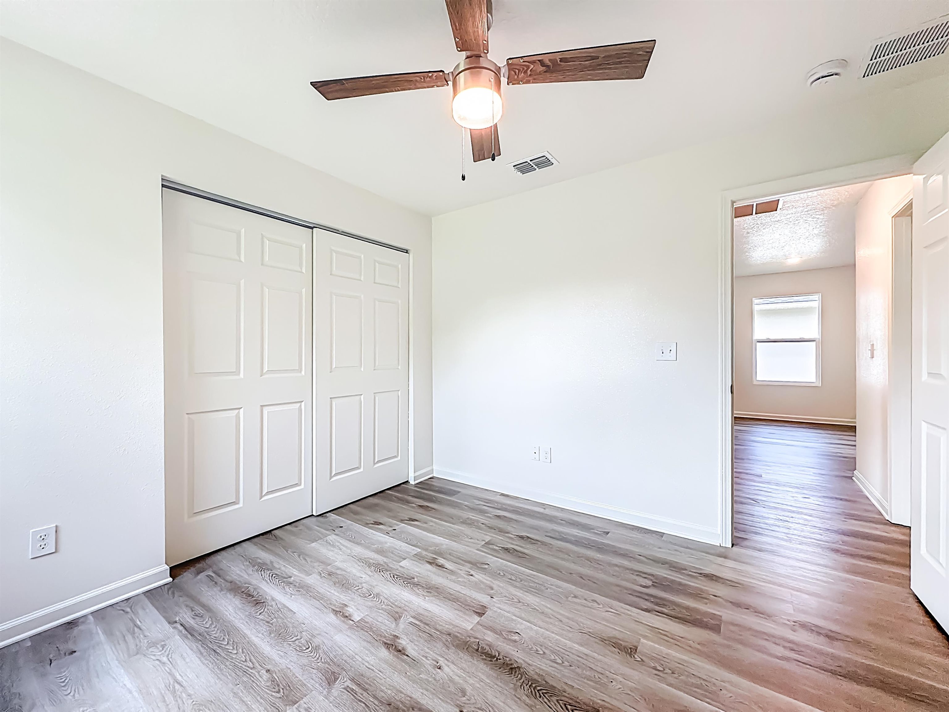 780 West 5th Street St. Augustine, FL 32084 - Photo 21 of 30 wooden floor in an empty room with a window