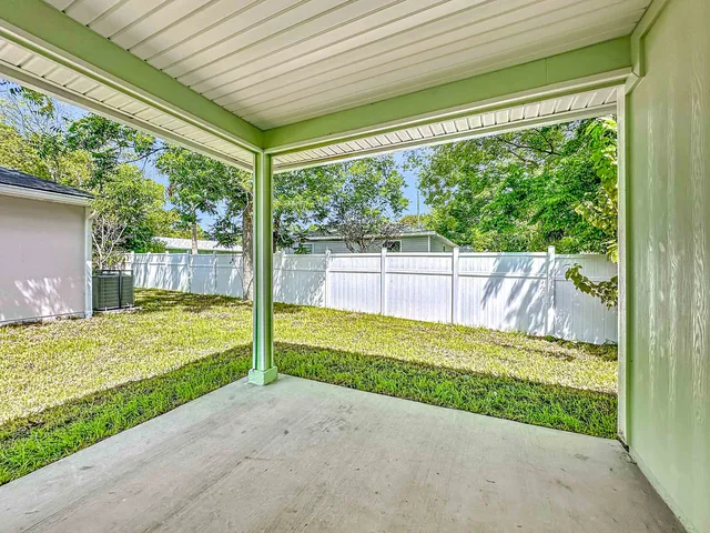 a view of a porch with furniture and garden