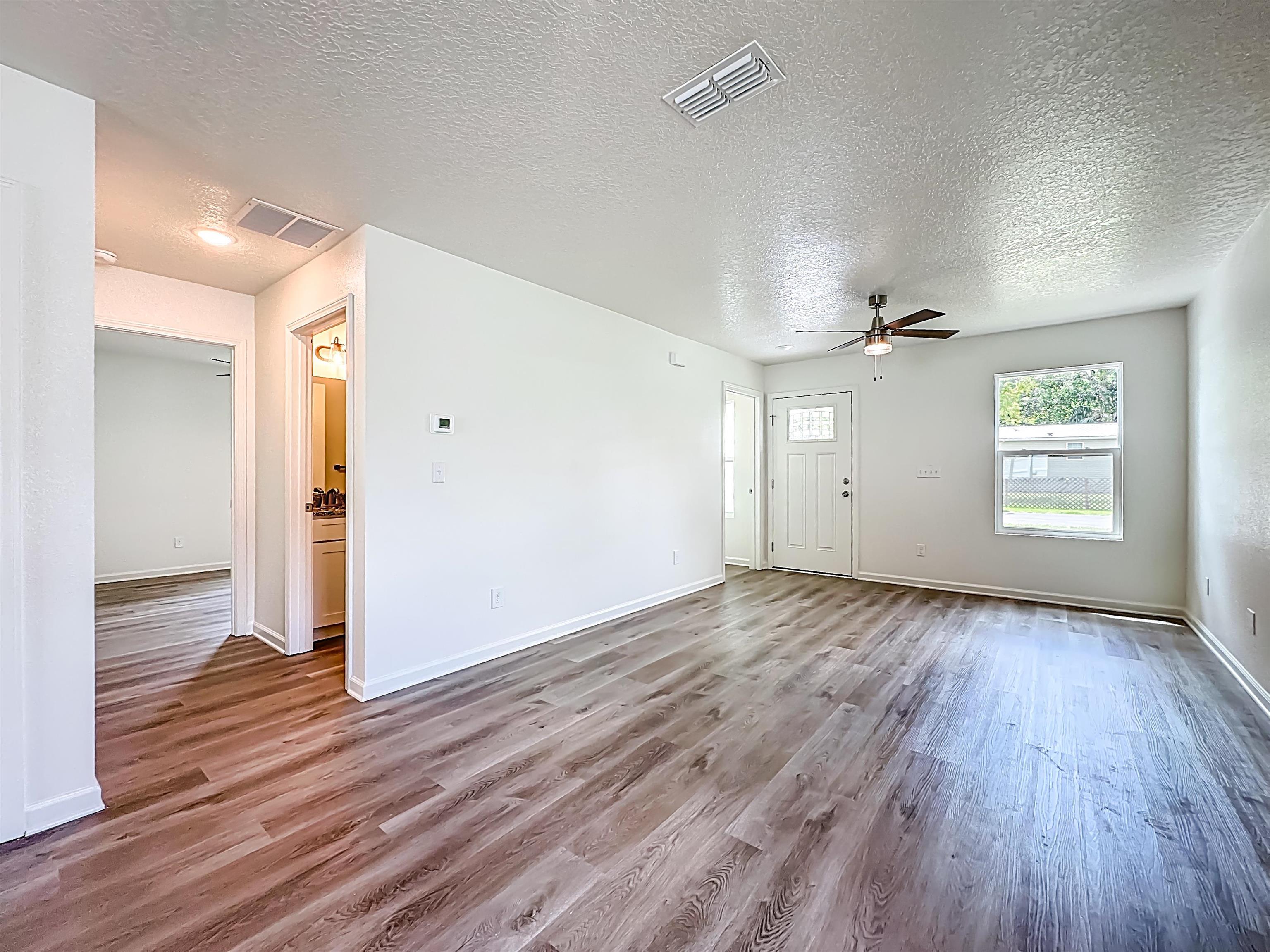 780 West 5th Street St. Augustine, FL 32084 - Photo 5 of 30 wooden floor in an empty room with a window