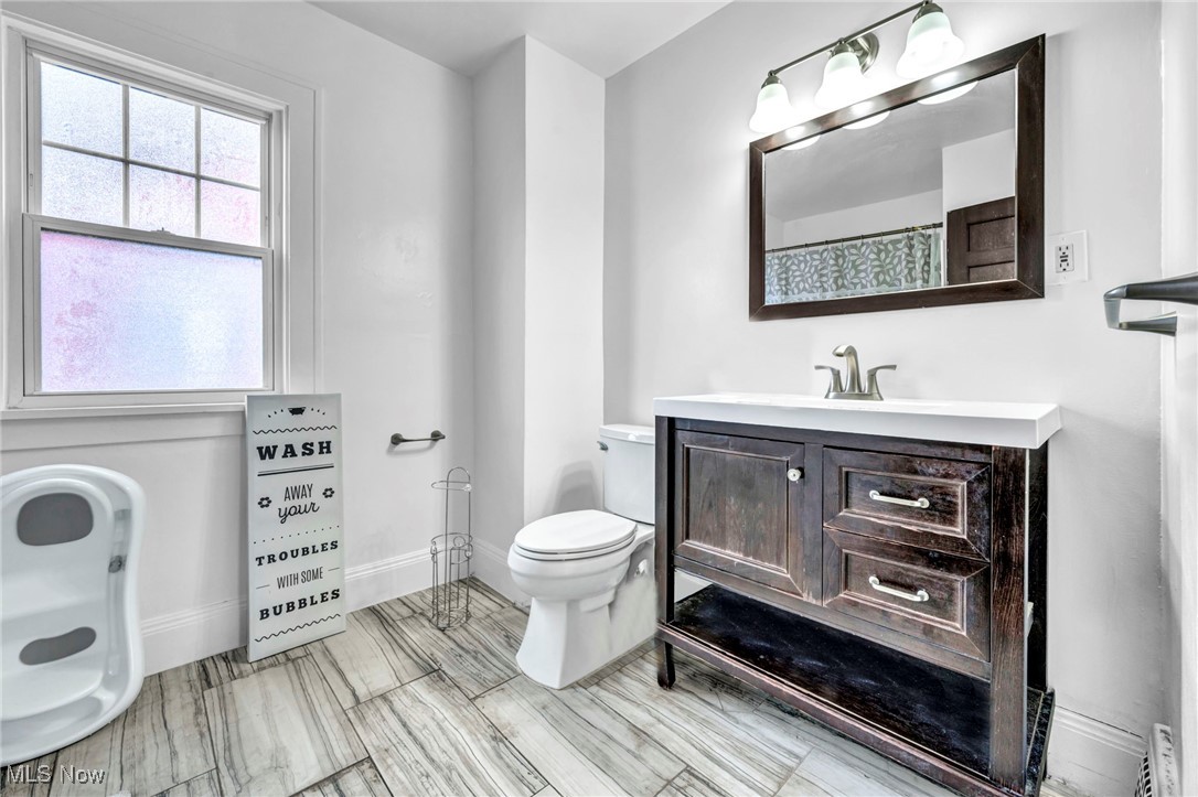 3403 Henderson Road Cleveland, OH 44112 - Photo 14 of 33 Bathroom featuring vanity, toilet, and walk in shower