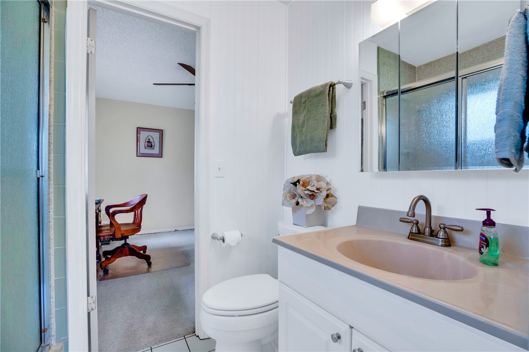 7666 134th Street Sebastian, FL 32958 - Photo 13 of 35 a bathroom with a toilet sink and mirror