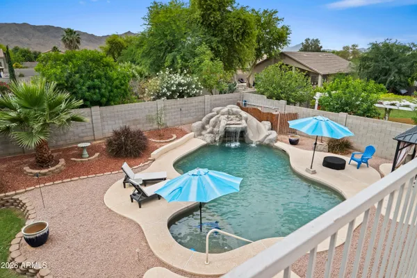 swimming pool view with a seating space