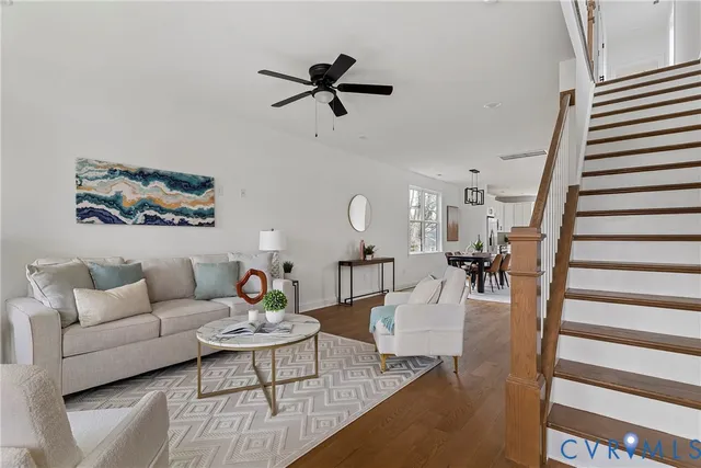 a living room with furniture and a wooden floor