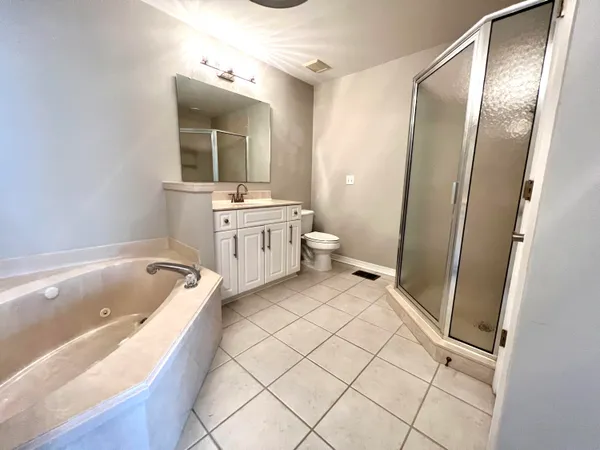 a bathroom with a tub sink and mirror