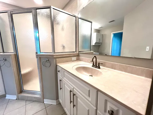 a bathroom with a double vanity sink and a mirror