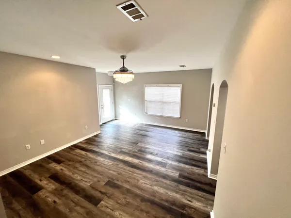 a view of room and window with wooden floor