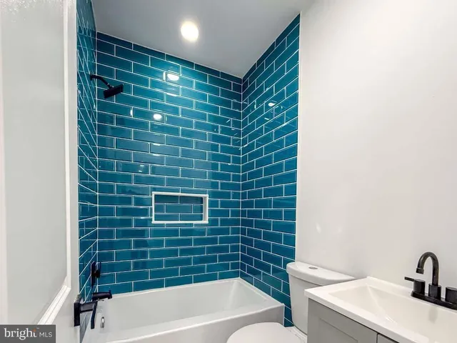 a bathroom with a bathtub and a sink