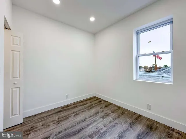 a view of room with wooden floor and window