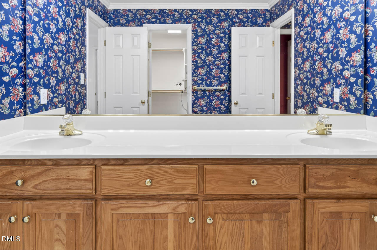 2209 Lodestar Drive Raleigh, NC 27615 - Photo 29 of 50 a bathroom with a sink and a mirror
