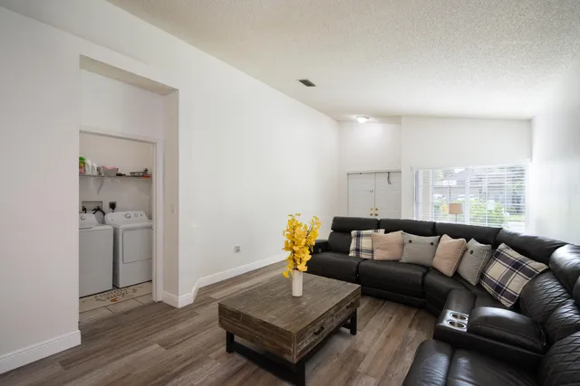 a living room with furniture and wooden floor