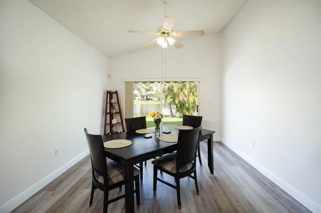 a view of a dining room with furniture and a window