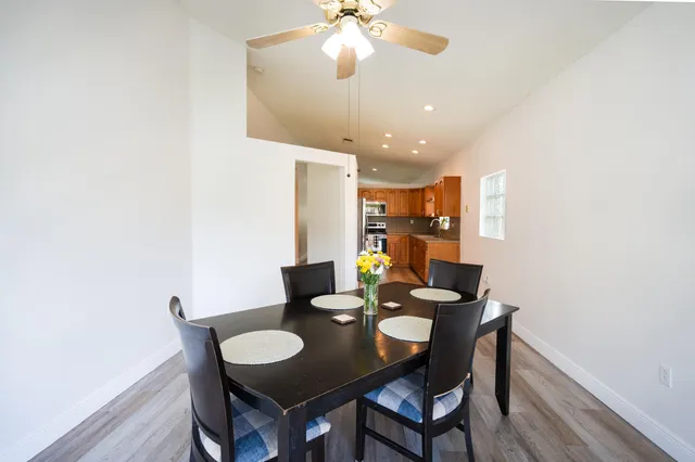 a view of a dining room with furniture and wooden floor