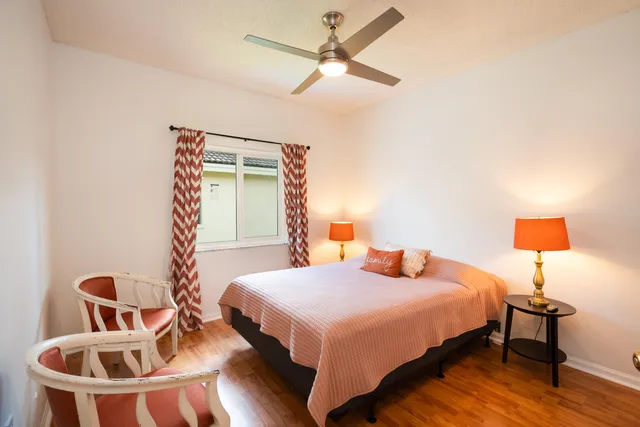 a bedroom with a bed and a lamp