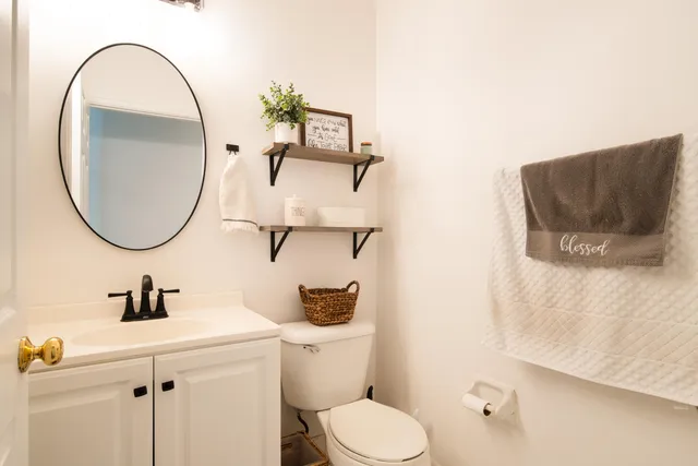 a bathroom with a toilet a sink and a mirror