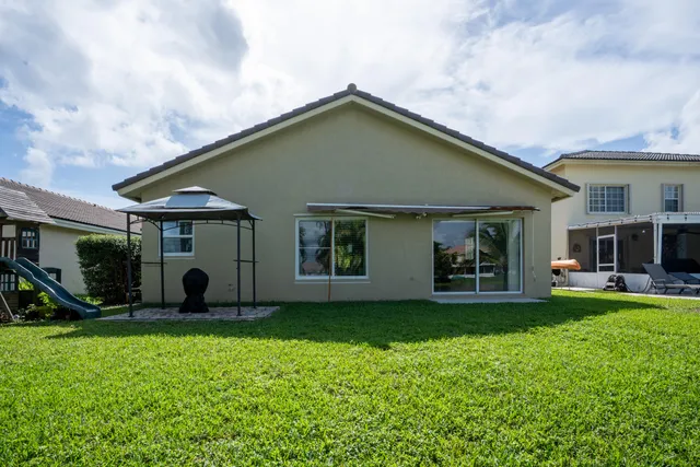 a front view of a house with a garden and plants