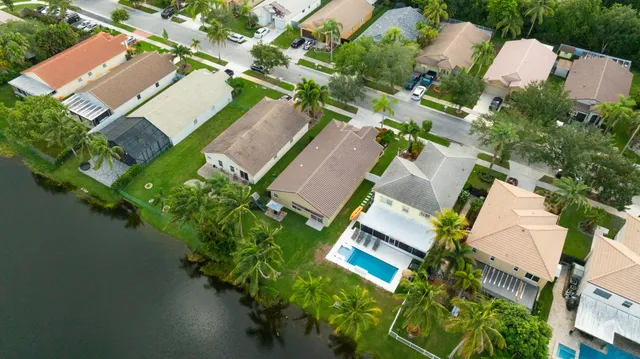 an aerial view of a house with outdoor space and lake view