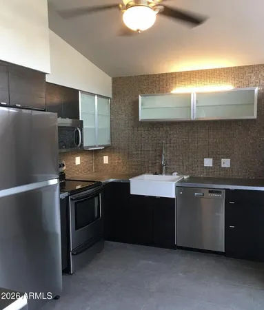 a kitchen with stainless steel appliances granite countertop a sink and a stove