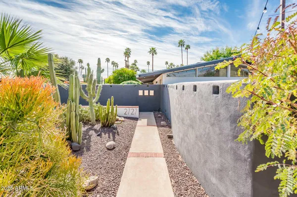 a view of a patio with a table and chairs