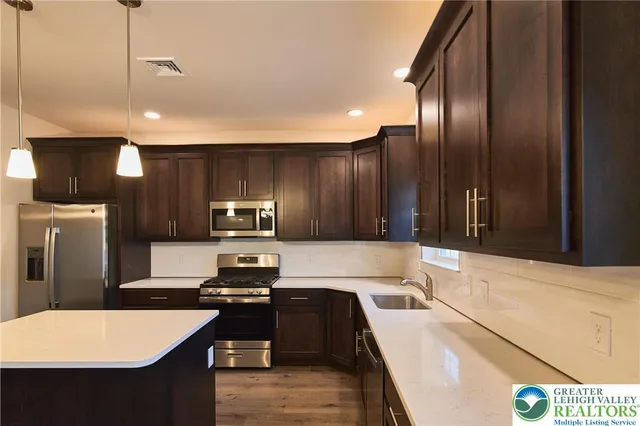 a kitchen with a refrigerator and a sink