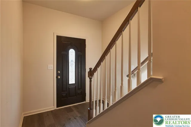 a view of staircase with railing and a window