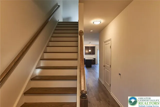 a view of entryway and hall with wooden floor