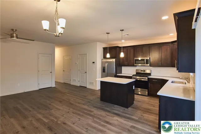 a view of kitchen with sink microwave and stove