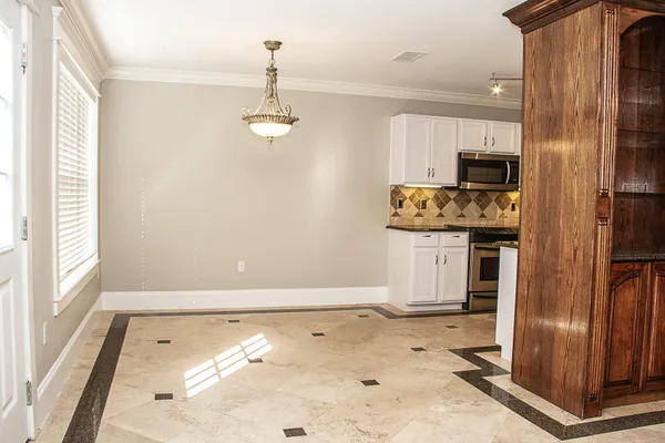 a view of a kitchen with a sink and refrigerator