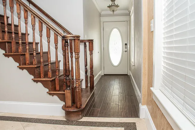 a view of staircase with wooden floor and a window