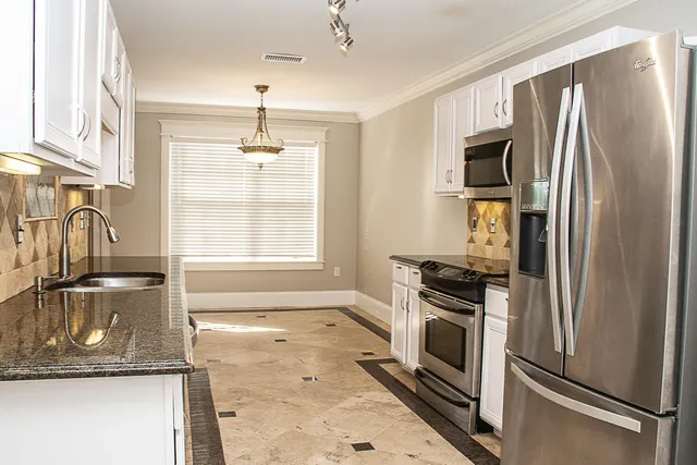 a kitchen with a refrigerator stove and sink