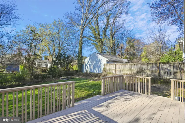 a balcony with wooden floor and fence