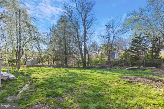 a backyard of a house with lots of green space and lake view